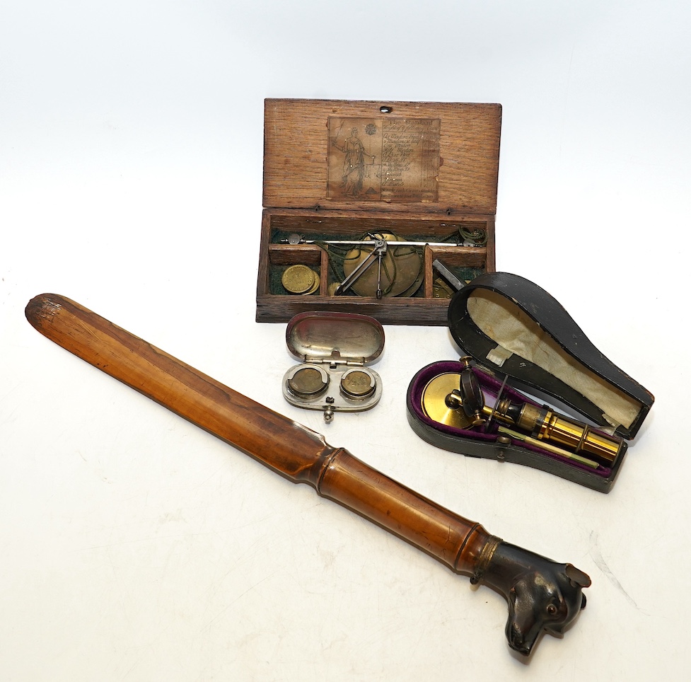 Sundry items comprising a Victorian travelling microscope, a sovereign case, a page turner in the form of a dog and scales. Condition - fair, general wear commensurate with age